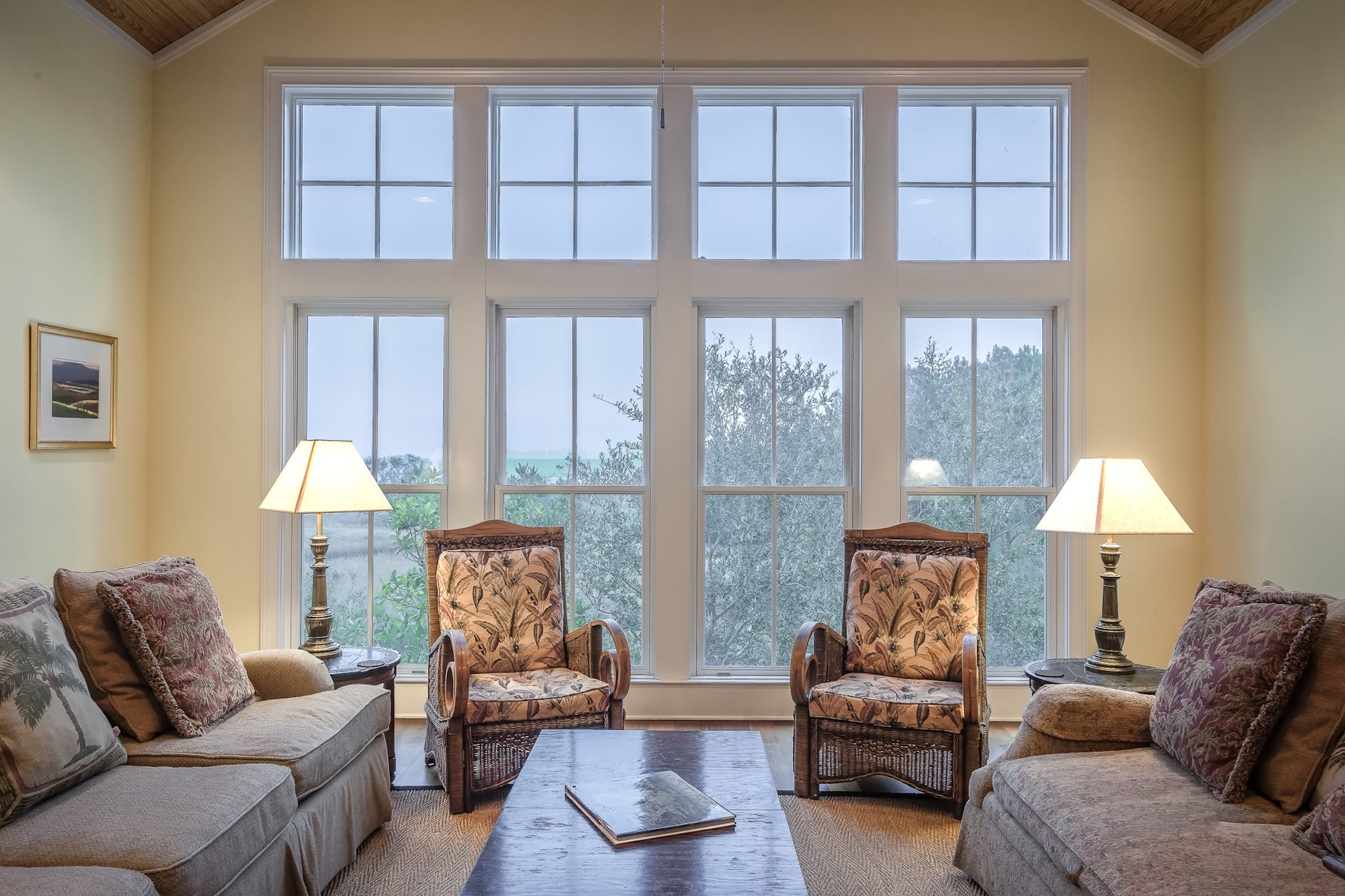 Living room with custom wood-clad replacement windows and vaulted ceiling